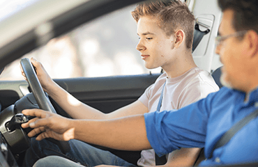 Learner driver with instructor in car
