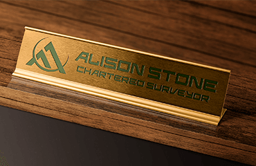 Name plate on desk with Alison Stone Chartered Surveyor written on it